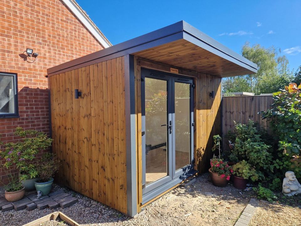 Garden room tucked into the corner by the house