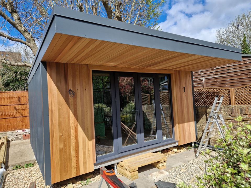 Cedar and steel garden room with bifold doors